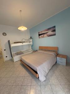 a bedroom with a bed in a room at Mare & Pineta in Punta Marina
