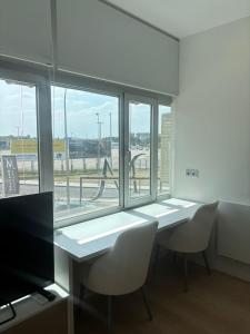a room with a table and chairs and a window at Aravaca Palm in Madrid