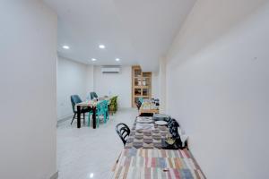 a room with a long table and chairs in it at Roomquet comfort in Prayagraj
