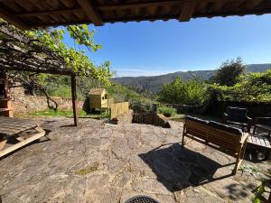 a bench sitting on a stone patio with a view at Retiro de Gondramaz - All house 200 m2 in Gondramaz