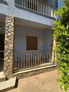 a balcony of a house with two chairs on it at Mare & Pineta in Punta Marina