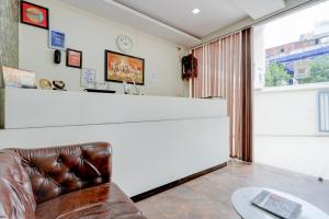a living room with a couch and a counter at Roomquet comfort in Prayagraj