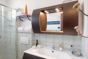 a bathroom with a sink and a mirror at Ca dei Tati -Citr 1181 with Jacuzzi in Imperia +32 photos