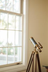 a telescope in front of a window at At Journey's End in St. Augustine +78 photos
