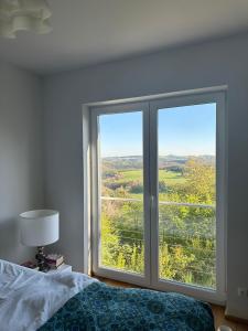 a bedroom with a bed and a large window at HeartArt 2 in Bad Münstereifel