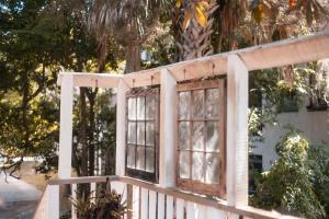 a window on the side of a white fence at At Journey's End in St. Augustine