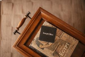 a picture of a wooden frame with a book in it at At Journey's End in St. Augustine