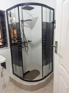 a shower with a glass enclosure in a bathroom at Hilltop Villa Sengabay in Salima +12 photos