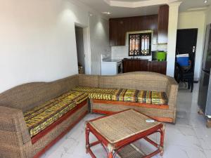 a living room with a couch and a table at Hilltop Villa Sengabay in Salima