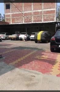 an image of a parking lot with cars parked at Hotel Atithi Palace in Jabalpur