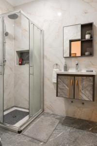 a bathroom with a shower and a sink at Praia City Apartments in Praia +17 photos