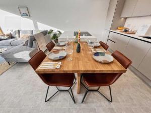 a wooden table in a living room with a couch at Damson Barn in Bluntisham