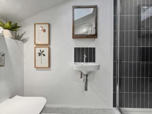 a bathroom with a sink and a mirror and a shower at Damson Barn in Bluntisham