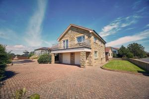 a stone house on a brick driveway at Host & Stay - Cheviot View in Seahouses