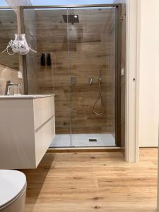 a bathroom with a shower with a glass door at Marra Home B&B in Barletta +8 photos