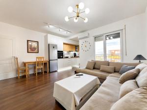 a living room with a couch and a table at Romantic Penthouse with Mountains View in Kashari +10 photos