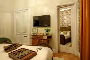 a room with a bedroom with a bed and a mirror at Hotel Parrasio in Rome