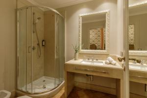 a bathroom with a sink and a shower at Hotel Parrasio in Rome +39 photos