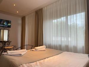 a bedroom with a bed and a large window at Suzana Garden in Venus +51 photos