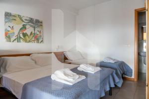 a bedroom with a bed and two tables with towels at Affittacamere Il Giardino in Alba Adriatica +65 photos