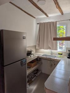 a kitchen with a refrigerator and a sink at Casa Brisa Marina El Yaque in El Yaque