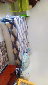 a room with a desk and a wall with a blanket at Hasparren in Hasparren