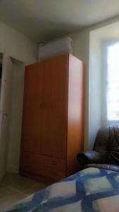 a bedroom with a dresser and a cabinet and a bed at Hasparren in Hasparren