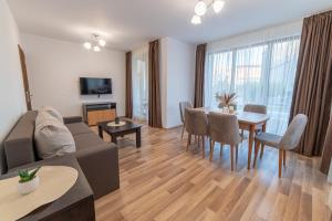 a living room with a couch and a table at Smokinite Villa 1 - Pool and BBQ near the beach in Varna City