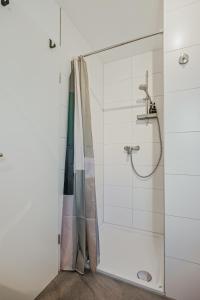 a bathroom with a shower with a glass door at Apartment am Fuchseck in Schorndorf +7 photos