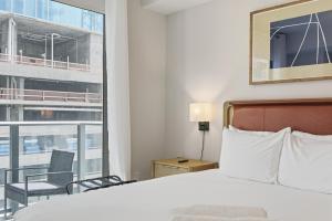 a hotel room with a bed and a balcony at Downtown Studio Steps from Kaseya Center in Miami +32 photos