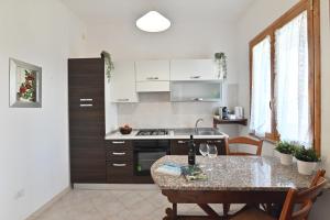 a kitchen with a table and a counter top at IzzHome Central in Pula