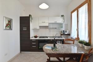 a kitchen with a table and a counter top at IzzHome Central in Pula +32 photos