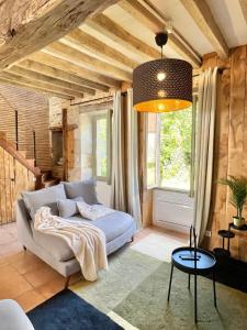 a living room with a couch and a large window at Baolocation Bouhy - Idéal famille & groupe d'amis -16min Guédelon - Wifi in Bouhy