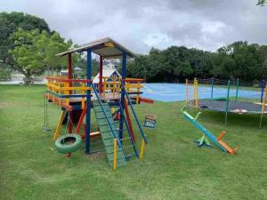 a park with a playground with a slide at Chalé Gravatá in Gravatá