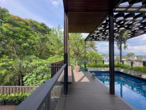 an external view of a house with a swimming pool at Depari Dago Villa in Bandung