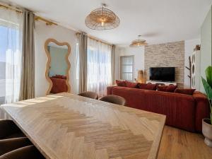 a living room with a table and a couch at Appartement Imalia Prestige et Elegance in Bray-Dunes