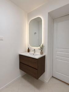 a bathroom with a sink and a mirror at Appartement Imalia Prestige et Elegance in Bray-Dunes +17 photos