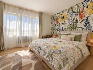 a bedroom with a large bed with a floral wallpaper at Appartement Imalia Prestige et Elegance in Bray-Dunes