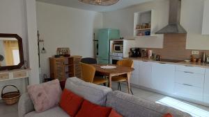 a living room with a couch and a table in a kitchen at Appartement T2 in Digne-les-Bains