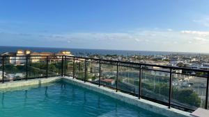 a swimming pool on top of a building at Full Studio in Stella Maris in Salvador