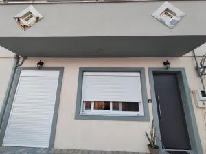 a house with two windows and a door at Sunrise House in Kefalos