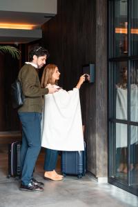 a man and a woman standing with their luggage at EHBoutique Experience in El Calafate