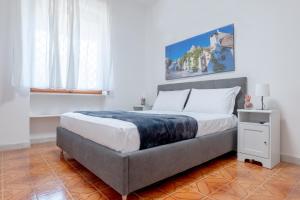 a bedroom with a large bed in a room at Baia Verde - Sea Rooms in Baia Verde