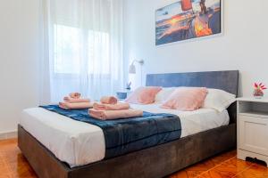 a bedroom with a bed with two teddy bears on it at Baia Verde - Sea Rooms in Baia Verde