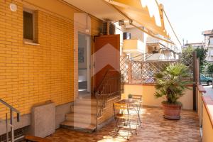 a balcony of a building with a staircase and a table at Affittacamere Il Giardino in Alba Adriatica