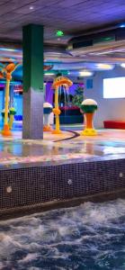 a room with a water park with many different colored fountains at AZ Appart hotels Saitour in Mazagran