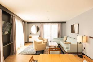 a living room with a couch and a table at AZ Appart hotels Saitour in Mazagran