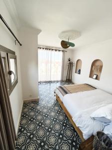 a bedroom with a bed and a large window at Riad D’AR GANne by Carole in Essaouira +76 photos