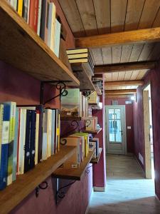 a row of books on shelves in a hallway at Tempo al Tempo in Villadeati