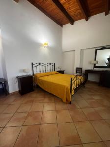 a bedroom with a bed with a yellow blanket at La terrazza del cilento in Perito +8 photos